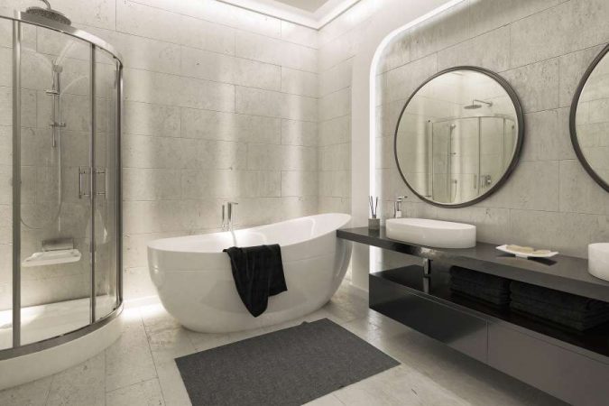 Une salle de bain moderne avec une baignoire îlot et un éclairage indirect, illustrant une décoration de salle de bain cocooning luxueuse.